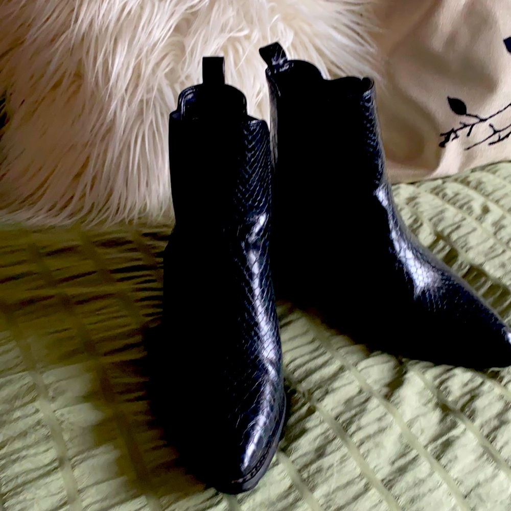 Snake skin black leather boots.